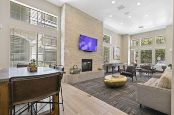 a living room with a fireplace and a table with chairs at Ascent Apartments, Cottonwood Heights Utah